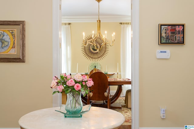 dining space featuring crown molding and an inviting chandelier