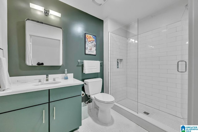 bathroom with toilet, tile patterned flooring, vanity, and a shower with door