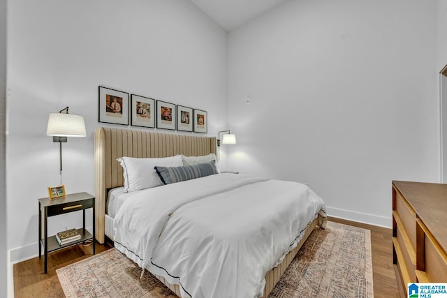 bedroom with hardwood / wood-style floors