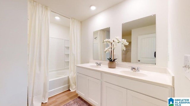 bathroom with vanity, shower / bath combo with shower curtain, and hardwood / wood-style flooring