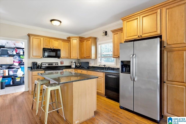 kitchen featuring a kitchen island, sink, black appliances, crown molding, and light hardwood / wood-style floors