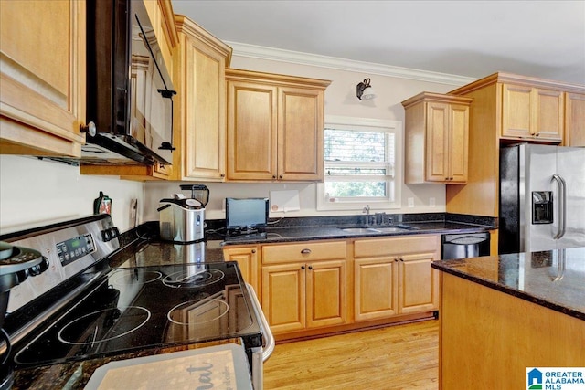 kitchen featuring dark stone countertops, sink, black appliances, crown molding, and light wood-type flooring