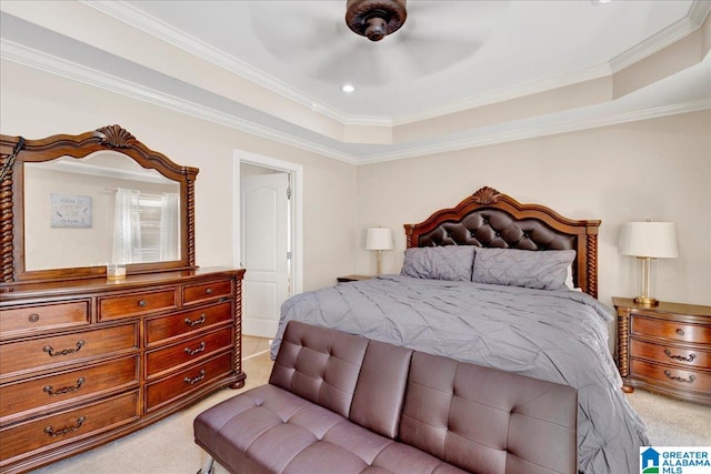 carpeted bedroom featuring ceiling fan, ornamental molding, and a tray ceiling