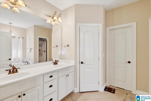 bathroom with vanity, a notable chandelier, and tile patterned flooring