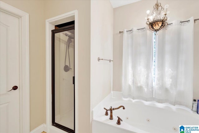 bathroom featuring plus walk in shower and an inviting chandelier