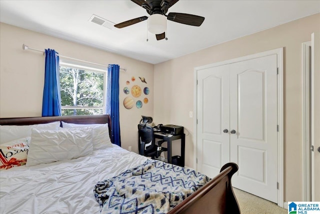 bedroom featuring a closet, light colored carpet, and ceiling fan