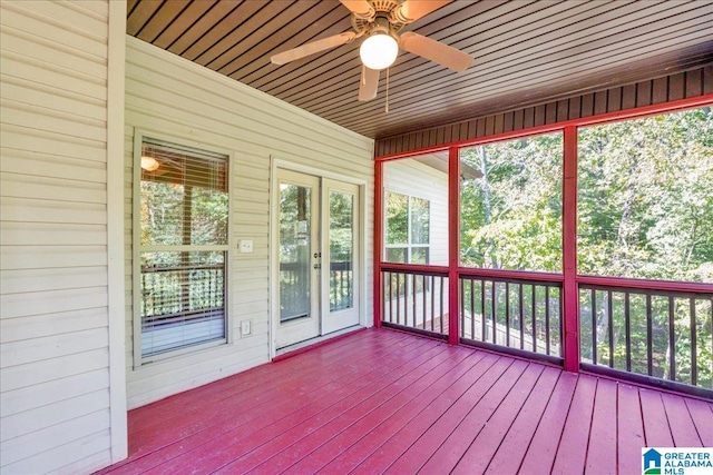 unfurnished sunroom with ceiling fan and wooden ceiling