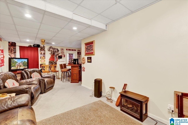 living room with a paneled ceiling