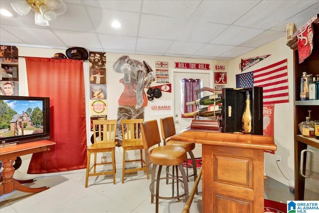 bar with a drop ceiling and ceiling fan