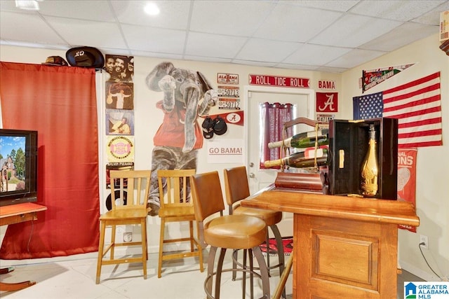 bar featuring a drop ceiling