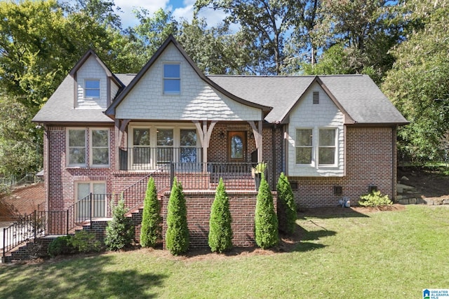 tudor home featuring a front lawn