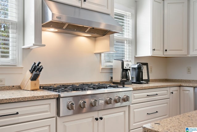 kitchen featuring light stone countertops, white cabinetry, and stainless steel gas cooktop