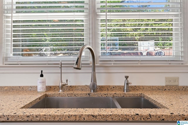 interior details with sink and light stone countertops