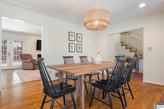 dining area with french doors and wood-type flooring