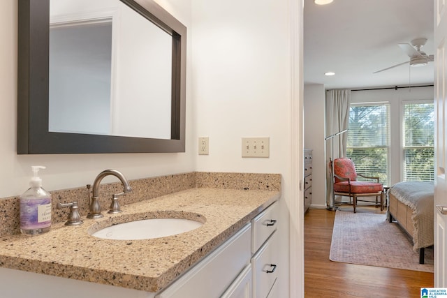 bathroom featuring vanity, hardwood / wood-style flooring, and ceiling fan