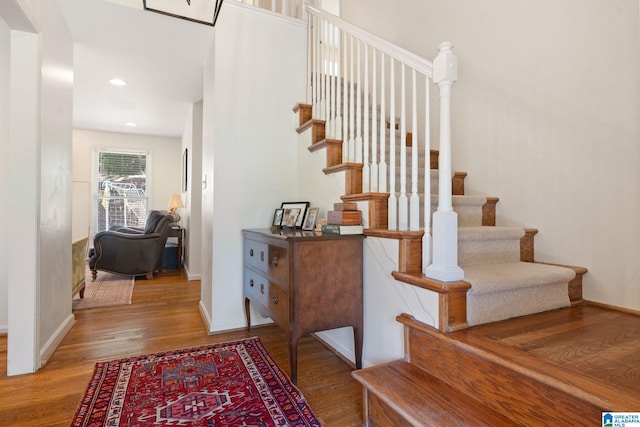 stairway with hardwood / wood-style flooring