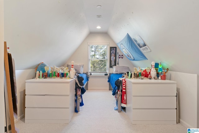 bedroom with lofted ceiling and light colored carpet