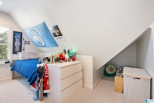 bedroom featuring lofted ceiling and light colored carpet