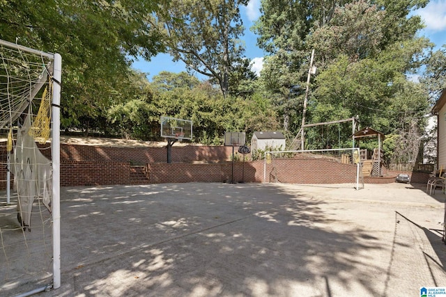 view of patio featuring basketball hoop