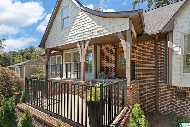 rear view of house featuring a porch