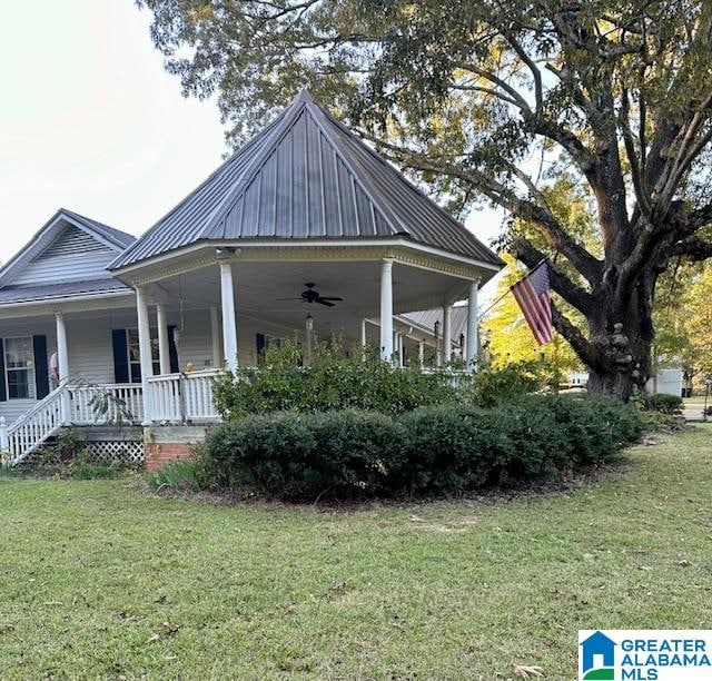 view of home's exterior featuring a lawn and a porch