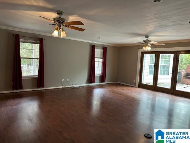 unfurnished room featuring a wealth of natural light, ceiling fan, ornamental molding, and hardwood / wood-style flooring