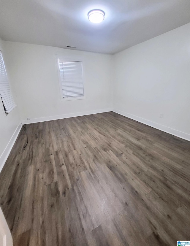 unfurnished room featuring dark hardwood / wood-style flooring