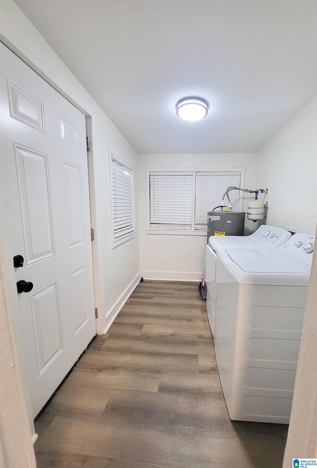 laundry area with separate washer and dryer and dark hardwood / wood-style floors