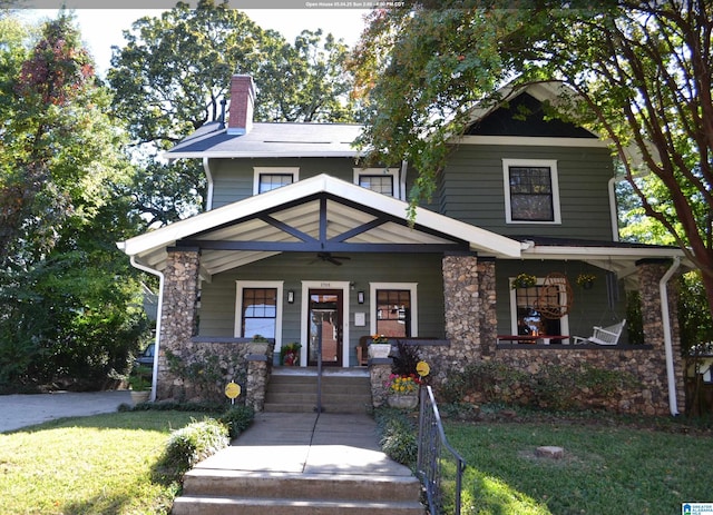 2705 Caldwell Ave S, Birmingham, AL 35205 - view of front of house with a porch, a ceiling fan, stone siding, a chimney, and a front yard