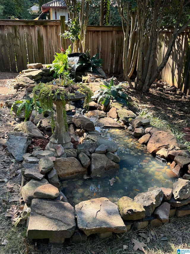 view of yard featuring a garden pond