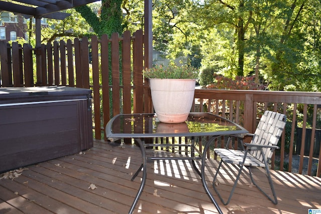 wooden deck with a hot tub