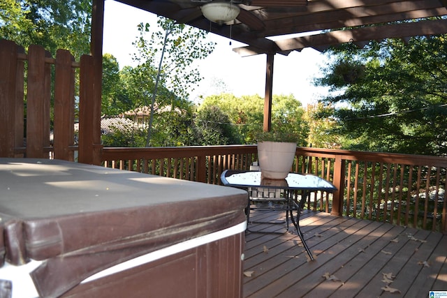 wooden deck with a hot tub and ceiling fan