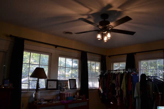 miscellaneous room featuring ceiling fan and a wealth of natural light