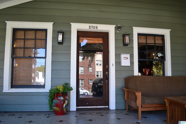 view of exterior entry with covered porch