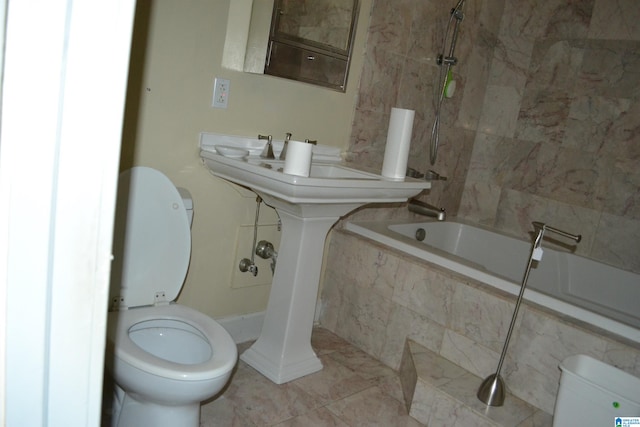 bathroom with tiled shower / bath combo and toilet