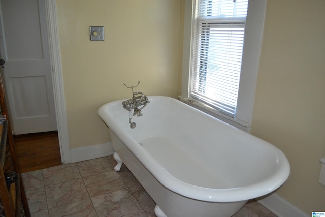 2705 Caldwell Ave S, Birmingham, AL 35205 - full bath featuring a freestanding tub, plenty of natural light, baseboards, and marble look tile flooring