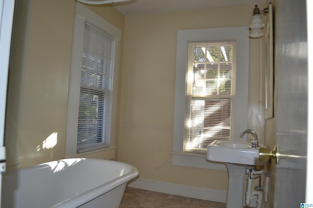 2705 Caldwell Ave S, Birmingham, AL 35205 - bathroom with a soaking tub and baseboards