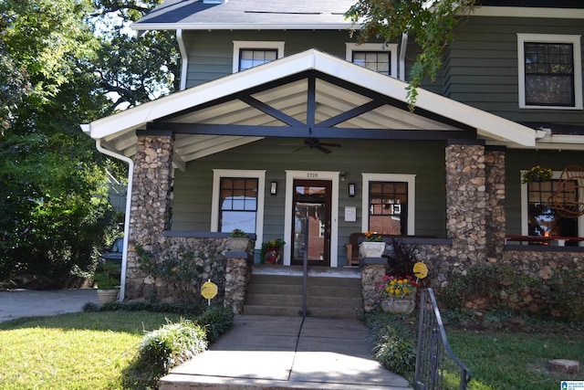 entrance to property featuring ceiling fan and covered porch