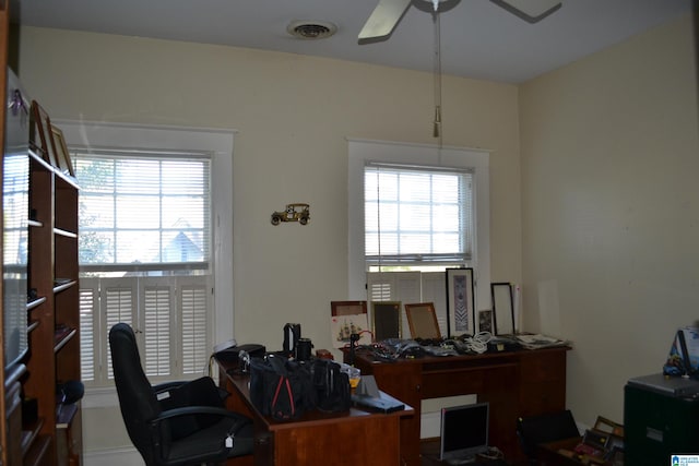 office area with plenty of natural light and ceiling fan