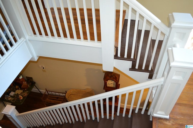 stairs with hardwood / wood-style flooring