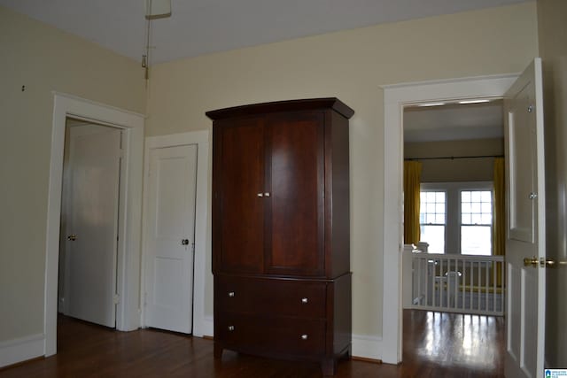 unfurnished bedroom featuring dark wood-type flooring