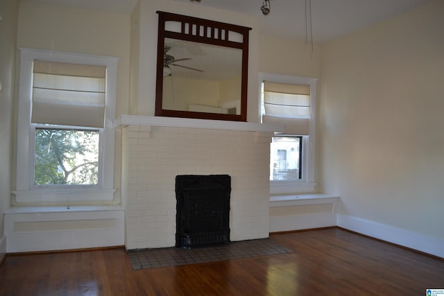 2705 Caldwell Ave S, Birmingham, AL 35205 - unfurnished living room with ceiling fan, a brick fireplace, wood finished floors, and plenty of natural light