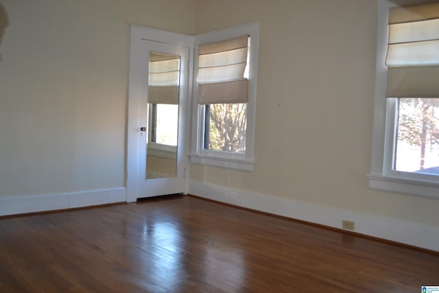 spare room with dark hardwood / wood-style floors