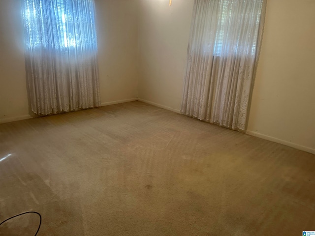 unfurnished room with light colored carpet