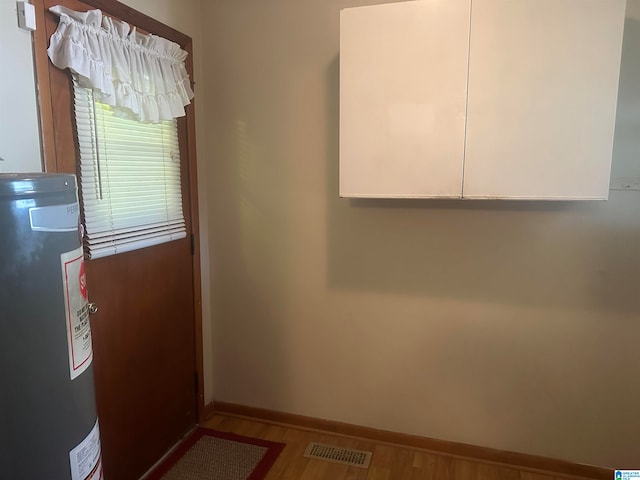 interior space with water heater and light hardwood / wood-style floors