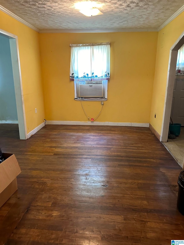 unfurnished room with dark wood-type flooring, crown molding, cooling unit, and a textured ceiling