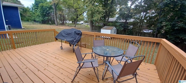 deck with a shed and a lawn