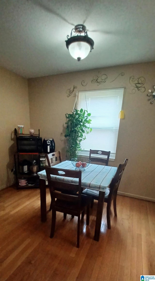 dining area with hardwood / wood-style flooring