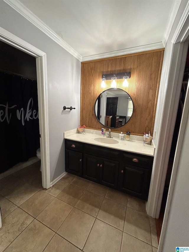 bathroom with vanity, ornamental molding, toilet, and tile patterned flooring