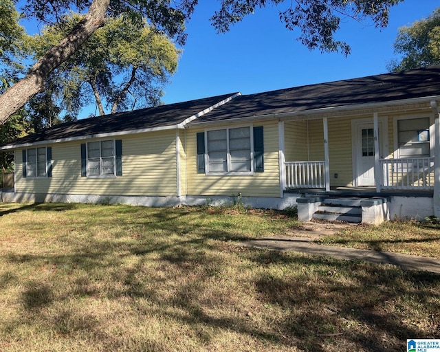 single story home with a front lawn and covered porch